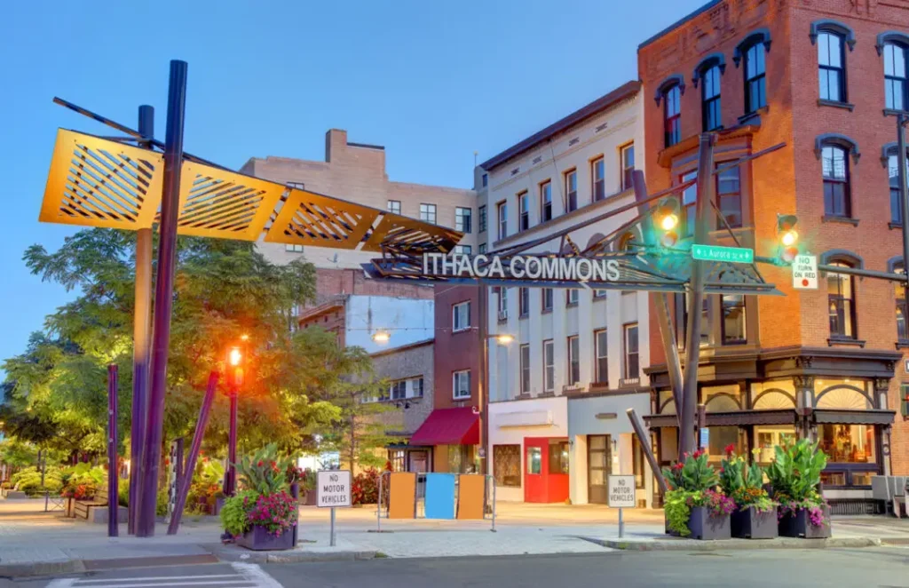 Evening view of Ithaca Commons with historic buildings and vibrant street lights.